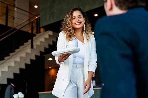 Een gastheer die een gast hartelijk verwelkomt bij de ingang van een vakantiehuis.