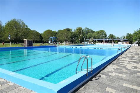 Foto van het verwarmde openlucht zwembad van Parkhotel Hierden met ligstoelen