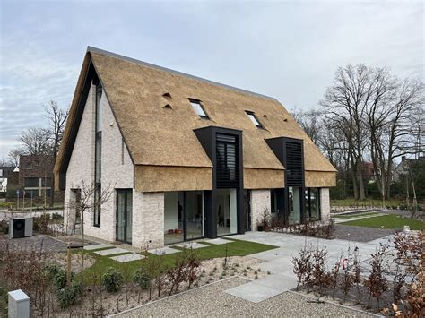 Artistieke impressie van het centrumgebouw van het vakantiepark met rieten dak.