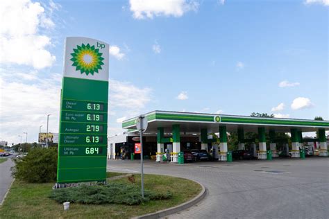 Een foto van een benzinestation op Curaçao met een medewerker die tankt