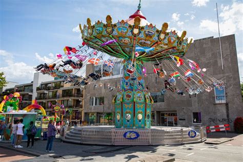 Kleurrijke zweefmolen El Mundo in werking met mensen in de stoelen