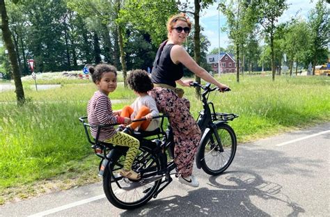 Een gezin dat fietst in Valencia, met een kind in een zitje achterop.