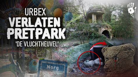 Een sfeerbeeld van het huidige verlaten terrein van De Vluchtheuvel, met overwoekerde paden en vervallen structuren.