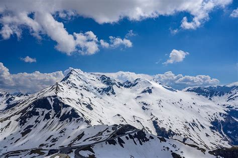 Alpenlandschap met besneeuwde bergtoppen en een dorpje in het dal