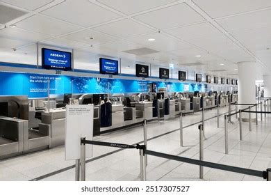 Interieur van de moderne Terminal 3 met check-in balies en bewegwijzering.