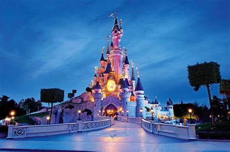 Een indrukwekkende avondfoto van het Kasteel van Doornroosje tijdens de Disney Illuminations show.